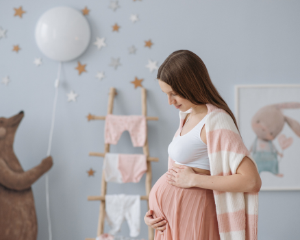 Happy pregnant woman in stylish maternity clothes